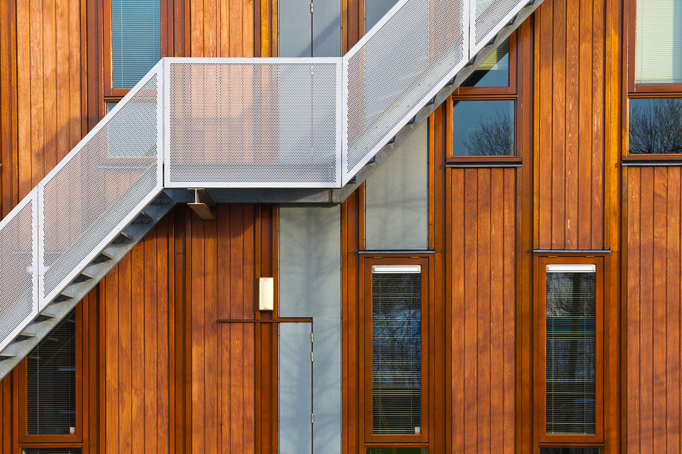 Metal stairs on a modern wooden facade